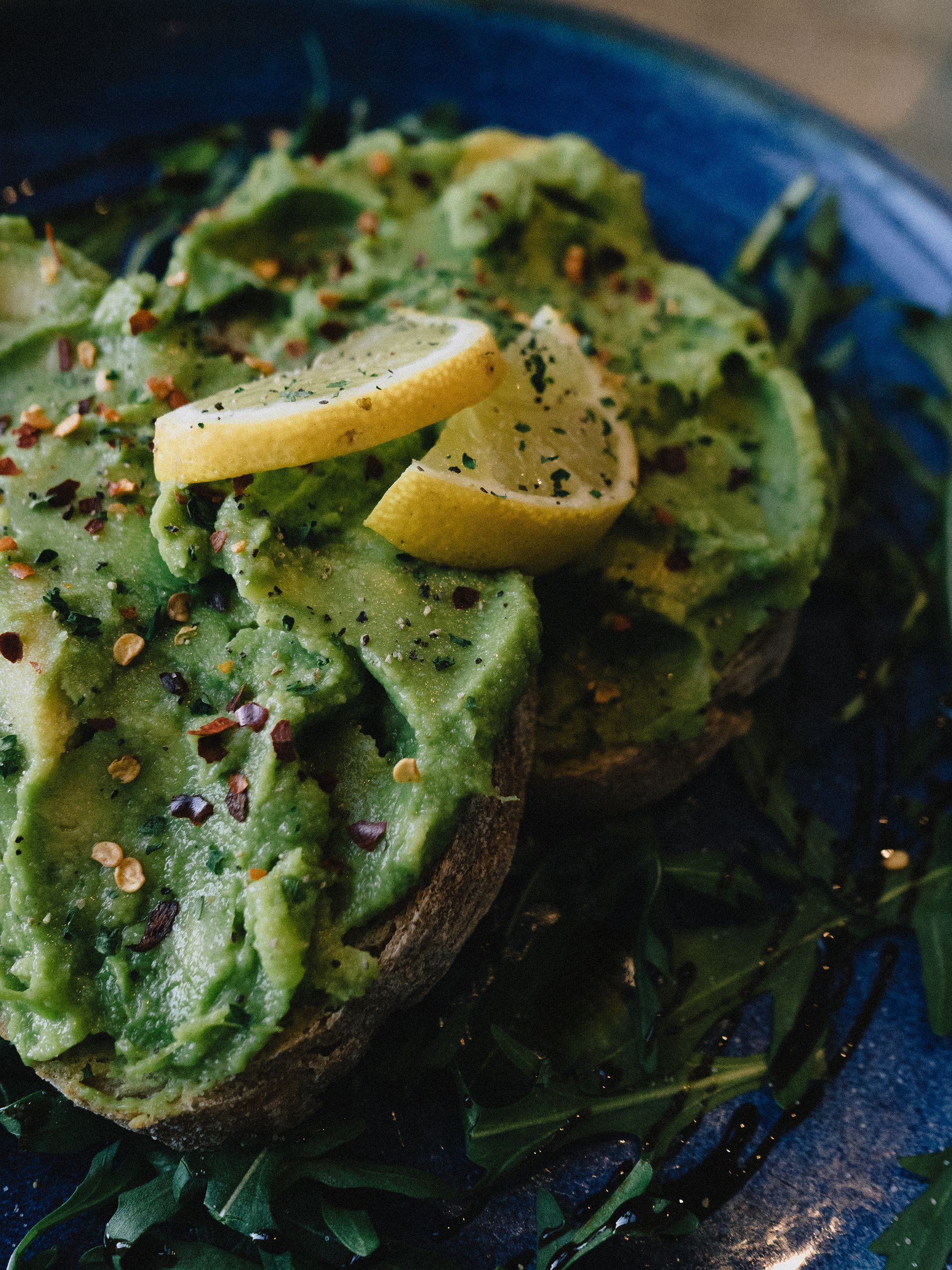 Smashed avocado on sourdough with confit tomato and lemon